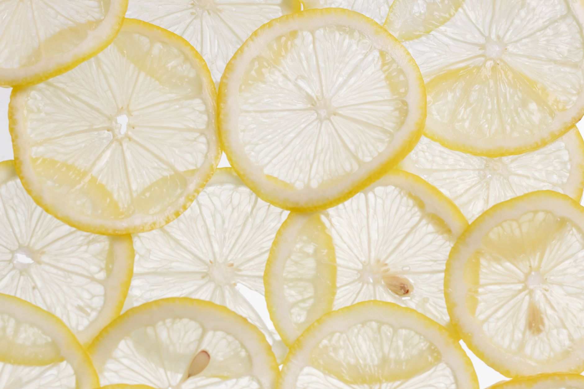 close up shot of slices of lemons on a white surface